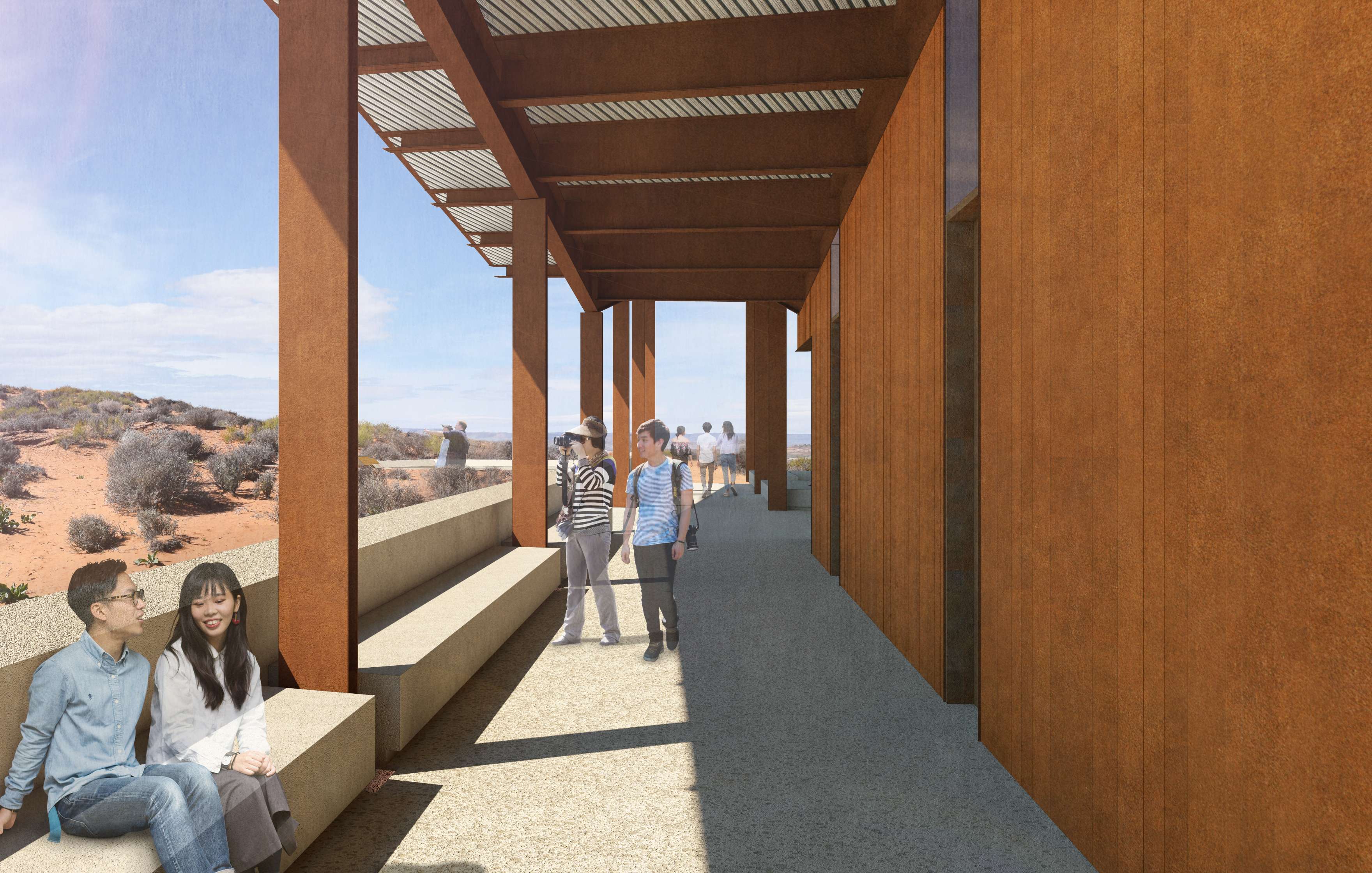 People are walking and sitting under a pergola structure in a desert environment. The building has rust-colored supports and benches built into the walkway. Desert landscape is visible in the background.