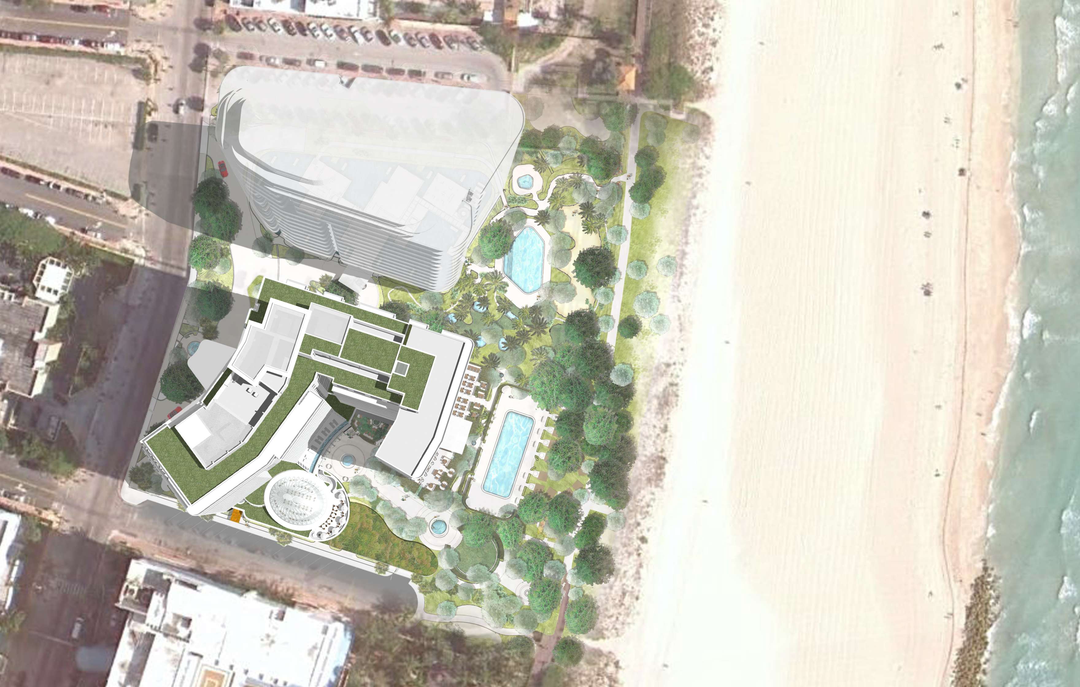 Aerial view of a modern beachfront hotel complex with pools, surrounded by greenery, next to a sandy beach and ocean.